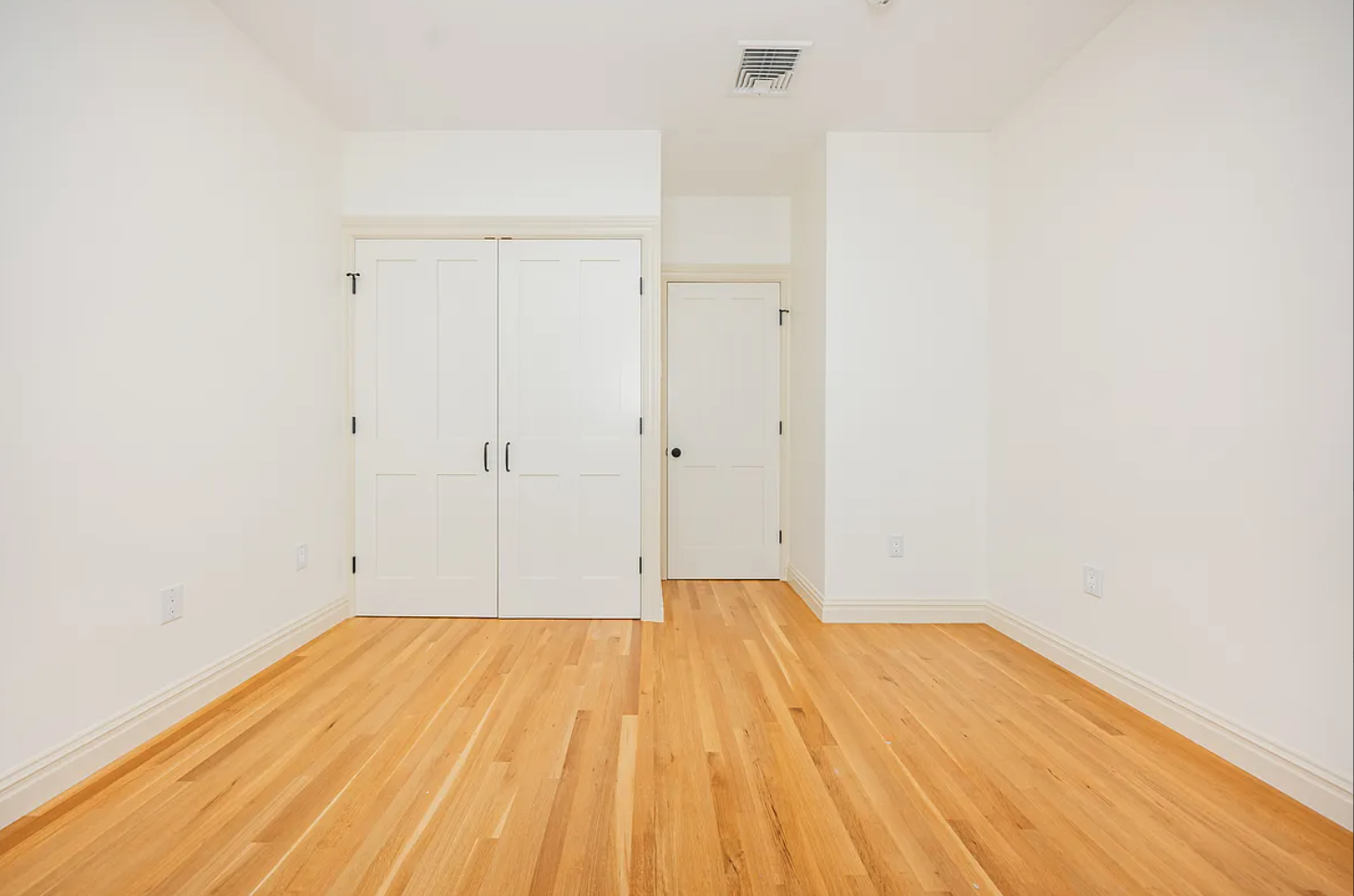 68-38 Forest Avenue, Unit 3R Queens, NY 11385 - Photo 11 of 15 a view of empty room with wooden floor
