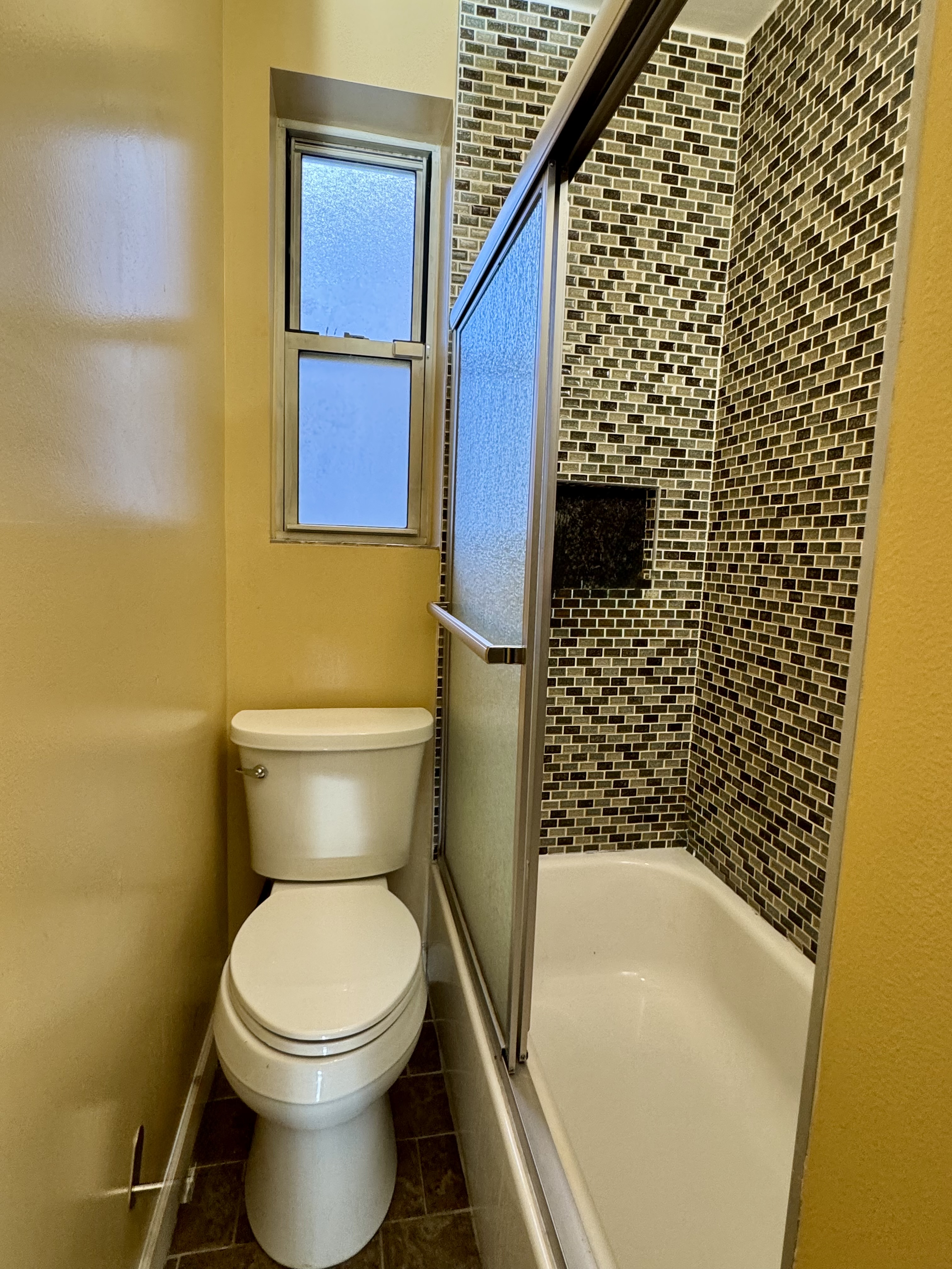 9281 Shore Road, Unit 207 Brooklyn, NY 11209 - Photo 9 of 11 a bathroom with a toilet and a shower