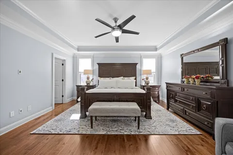 wooden floor in a room with a bookshelf and a large window