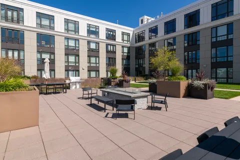 a swimming pool with outdoor seating and a potted plants