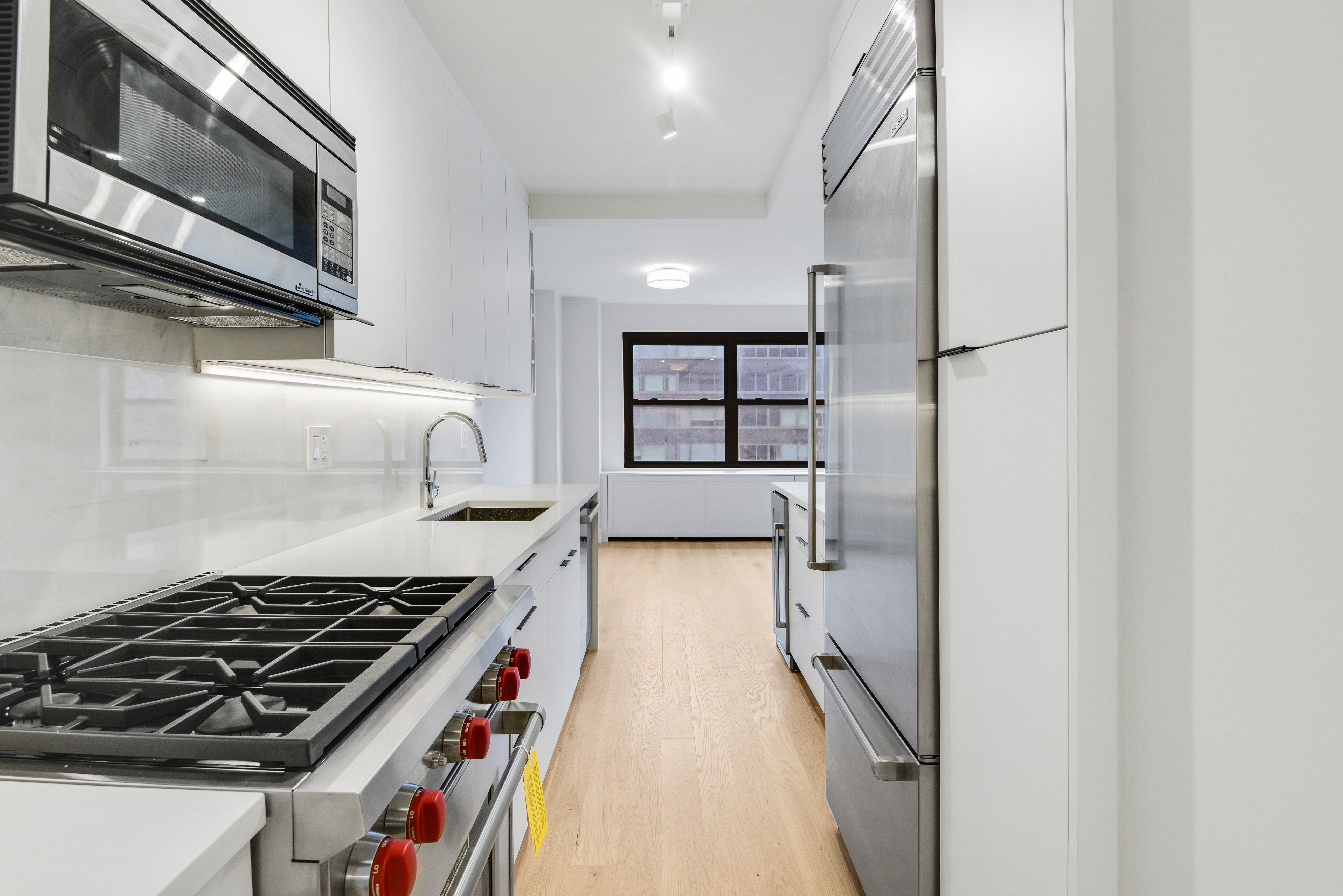 205 West End Avenue, Unit 15H Manhattan, NY 10023 - Photo 6 of 17 a kitchen with stainless steel appliances granite countertop a stove and a refrigerator