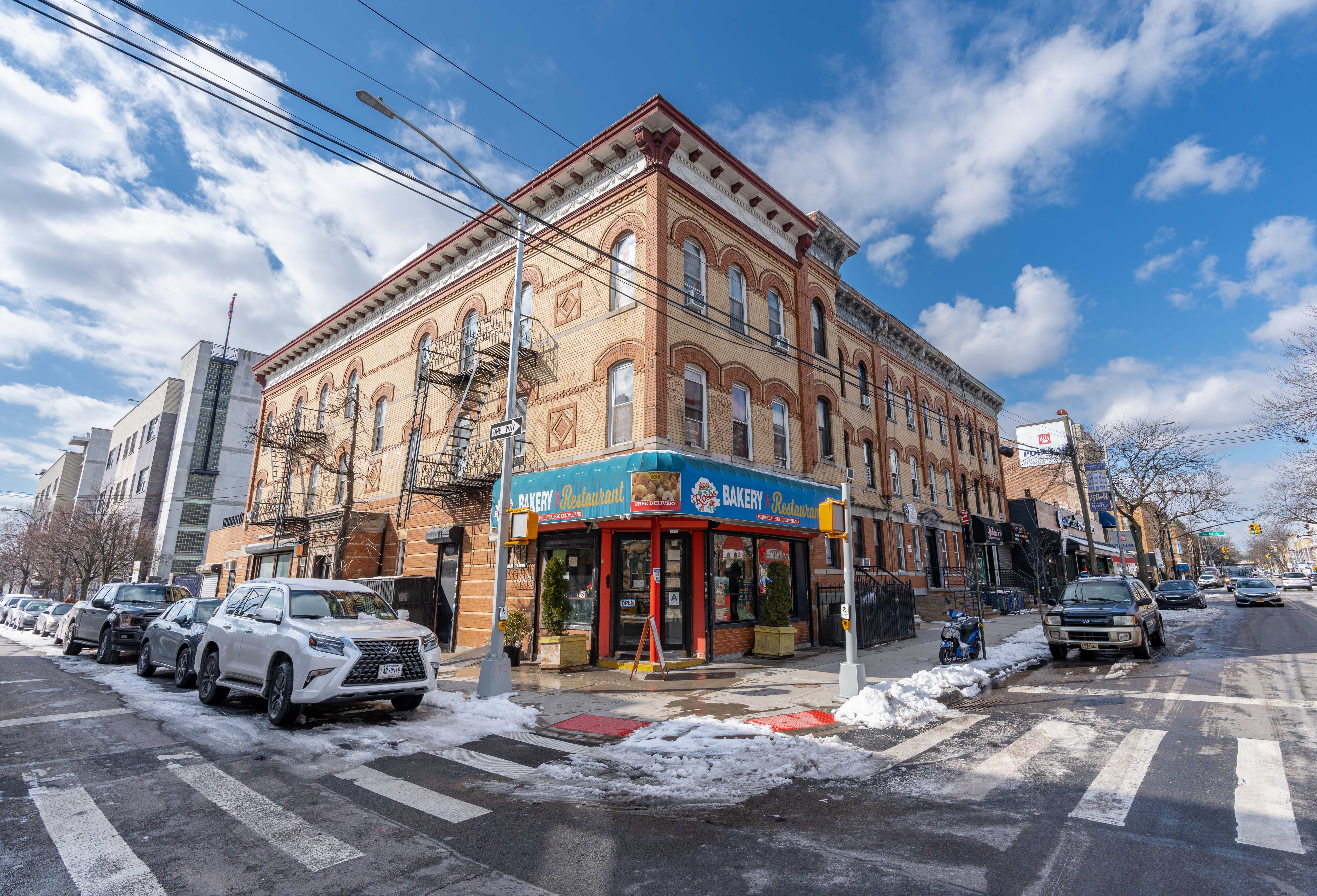 936 Seneca Avenue Queens, NY 11385 - Photo 1 of 12 a car parked in front of a building