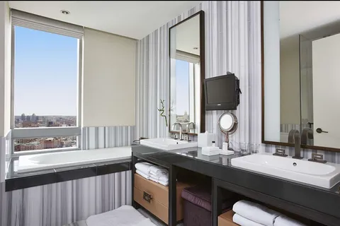 a bathroom with a double vanity sink and a mirror