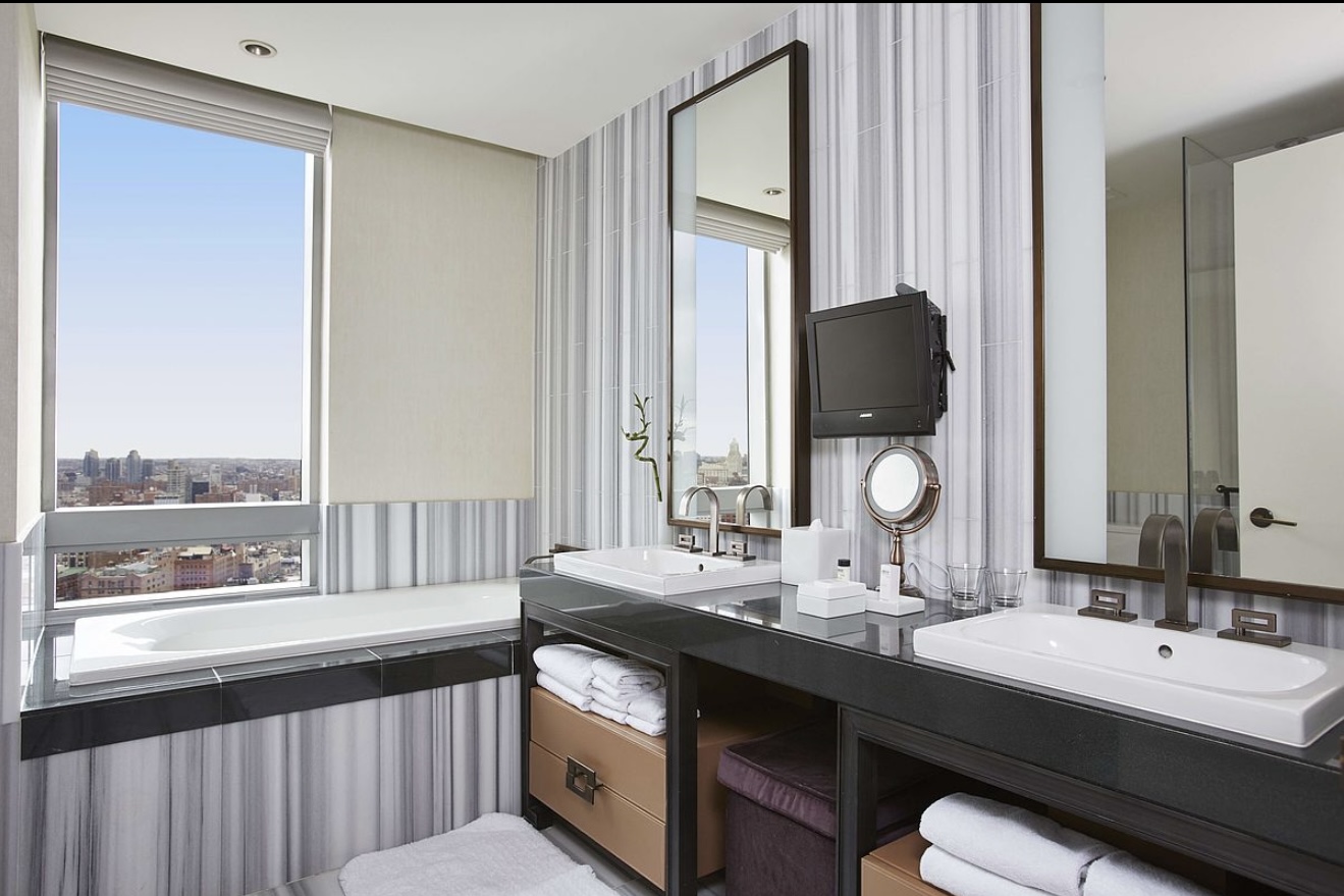 246 Spring Street, Unit 3503 Manhattan, NY 10013 - Photo 6 of 13 a bathroom with a double vanity sink and a mirror