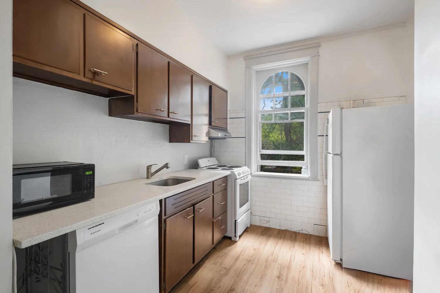 a kitchen with stainless steel appliances granite countertop a stove a sink and a refrigerator