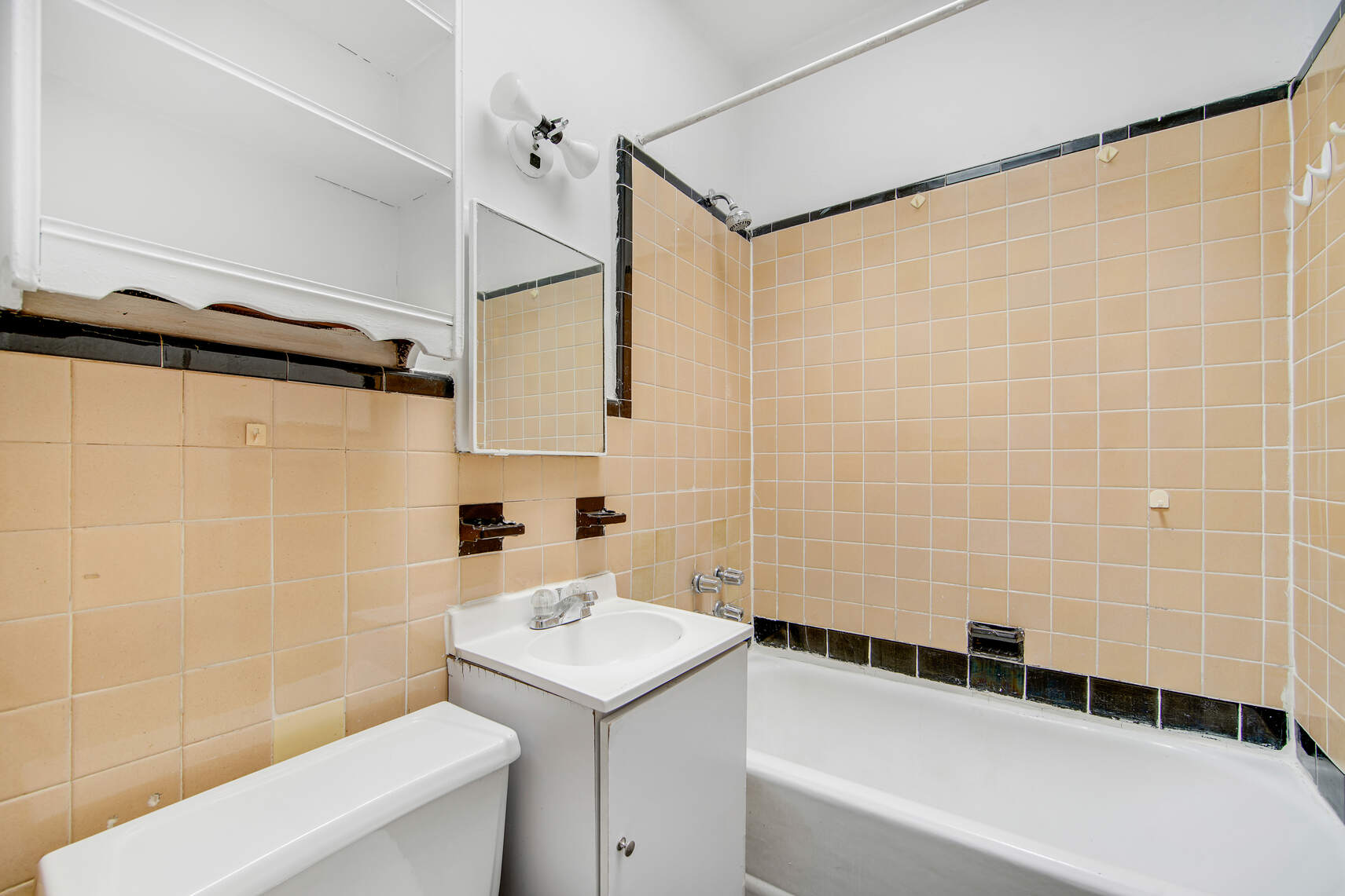 337 East 18th Street Manhattan, NY 10003 - Photo 14 of 16 a bathroom with a sink a toilet and shower