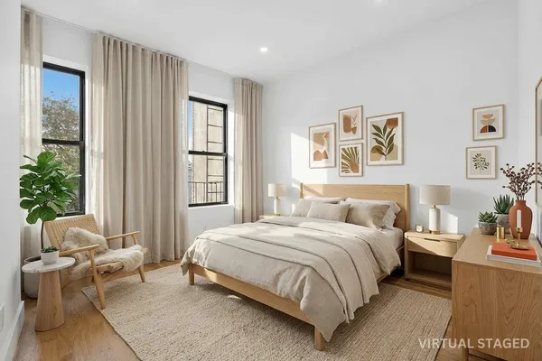 a bedroom with a bed and a couch