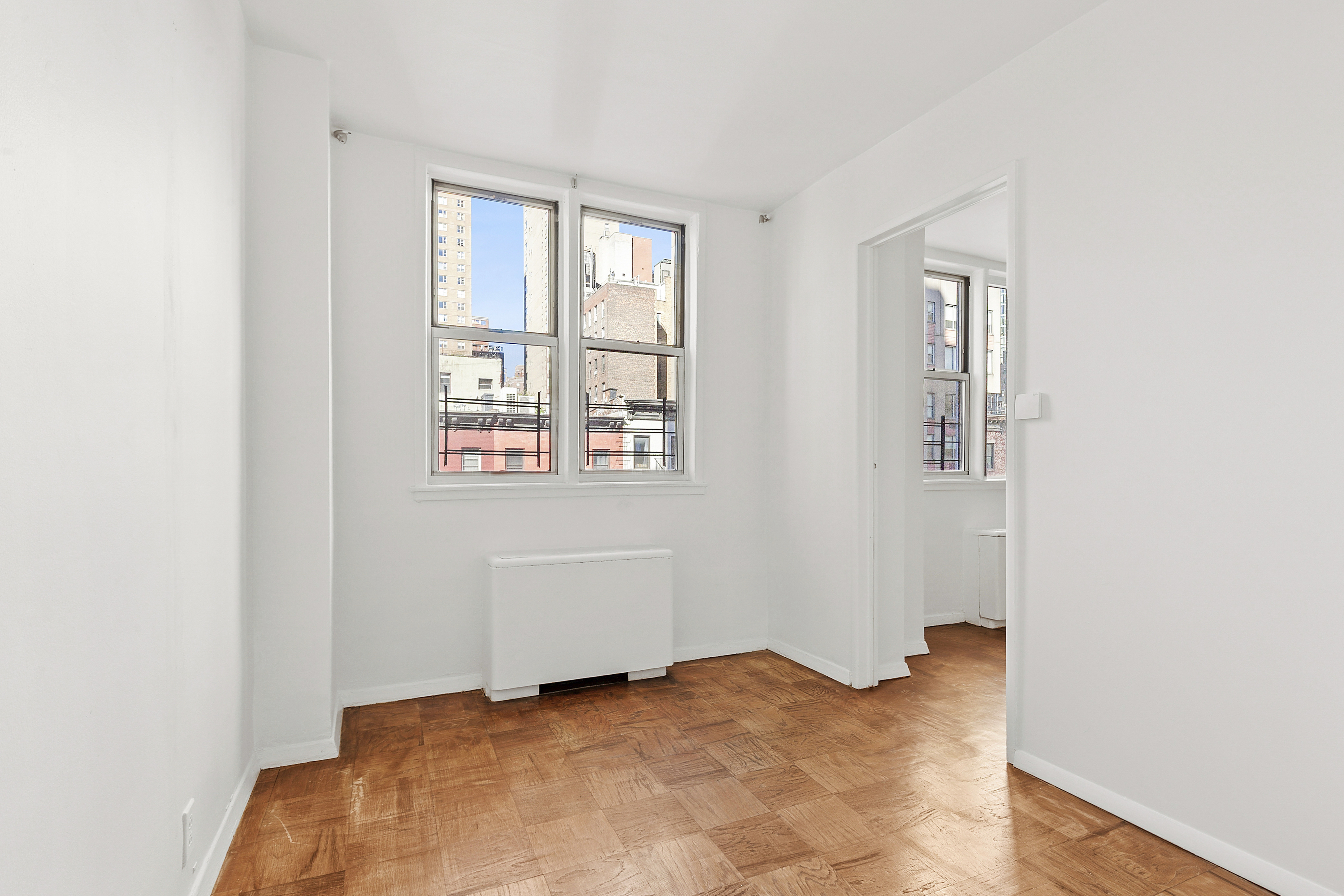 201 East 36th Street, Unit 5D Manhattan, NY 10016 - Photo 5 of 9 a view of an empty room with windows