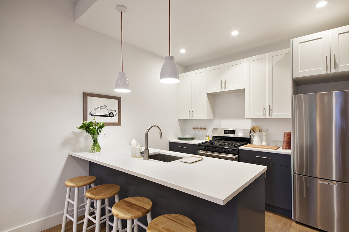 629 Grand Street, Unit 4A Brooklyn, NY 11211 - Photo 2 of 7 a kitchen with stainless steel appliances a sink and a refrigerator