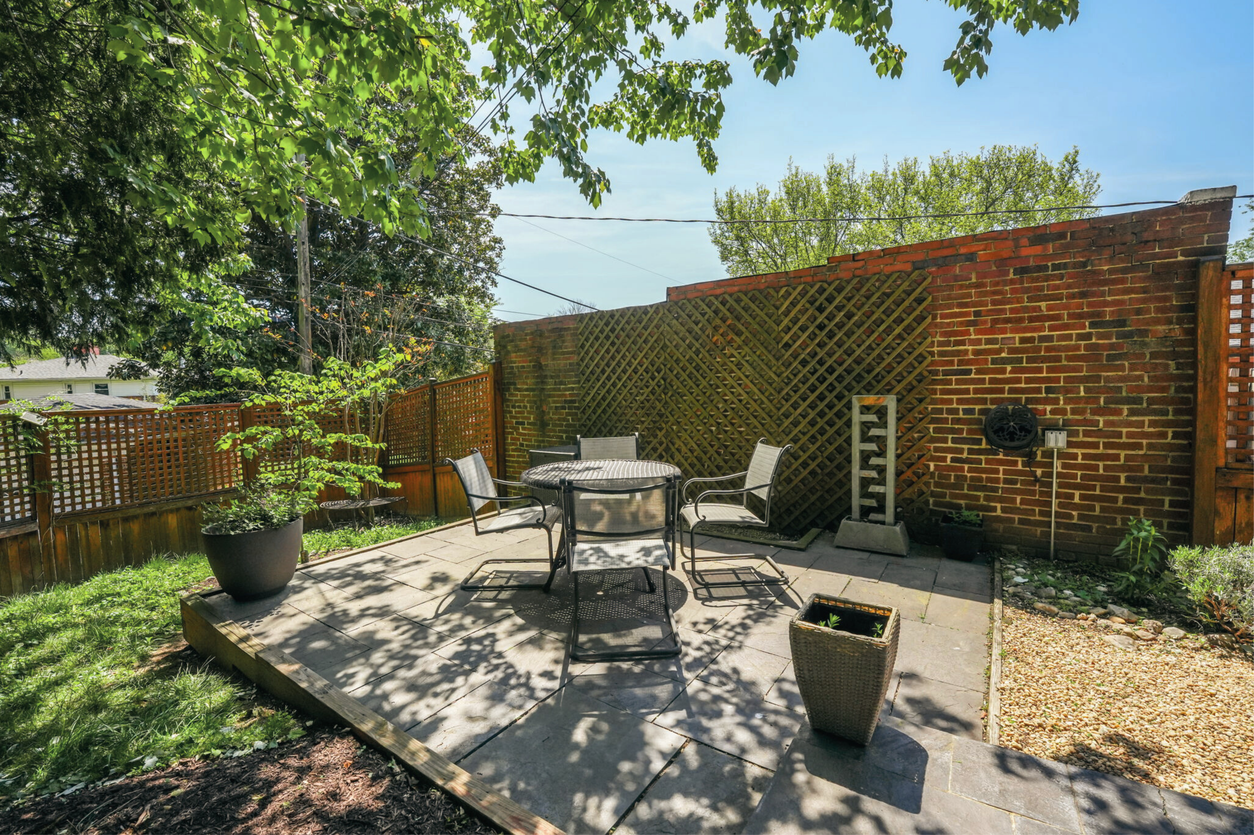 8003 16th Street Northwest Washington, DC 20012 - Photo 7 of 38 a view of a patio with table and chairs potted plants with wooden fence