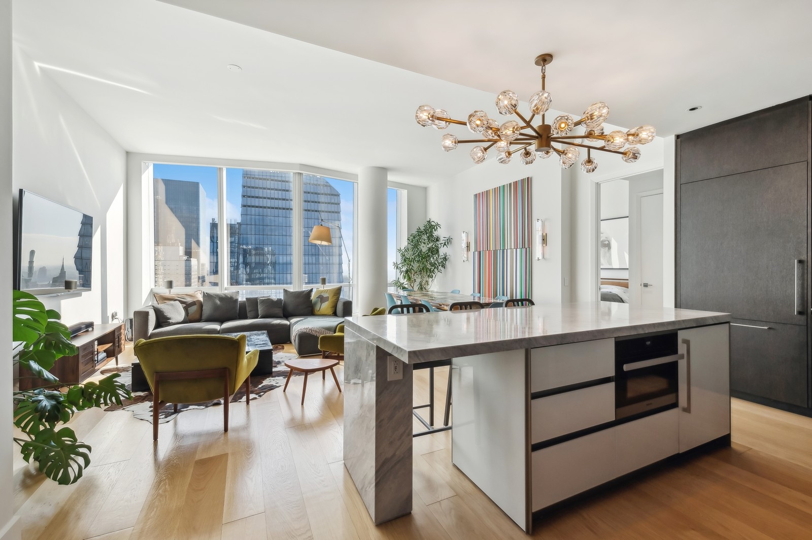 15 Hudson Yards, Unit 74F Manhattan, NY 10001 - Photo 3 of 13 a living room with furniture a chandelier and a window