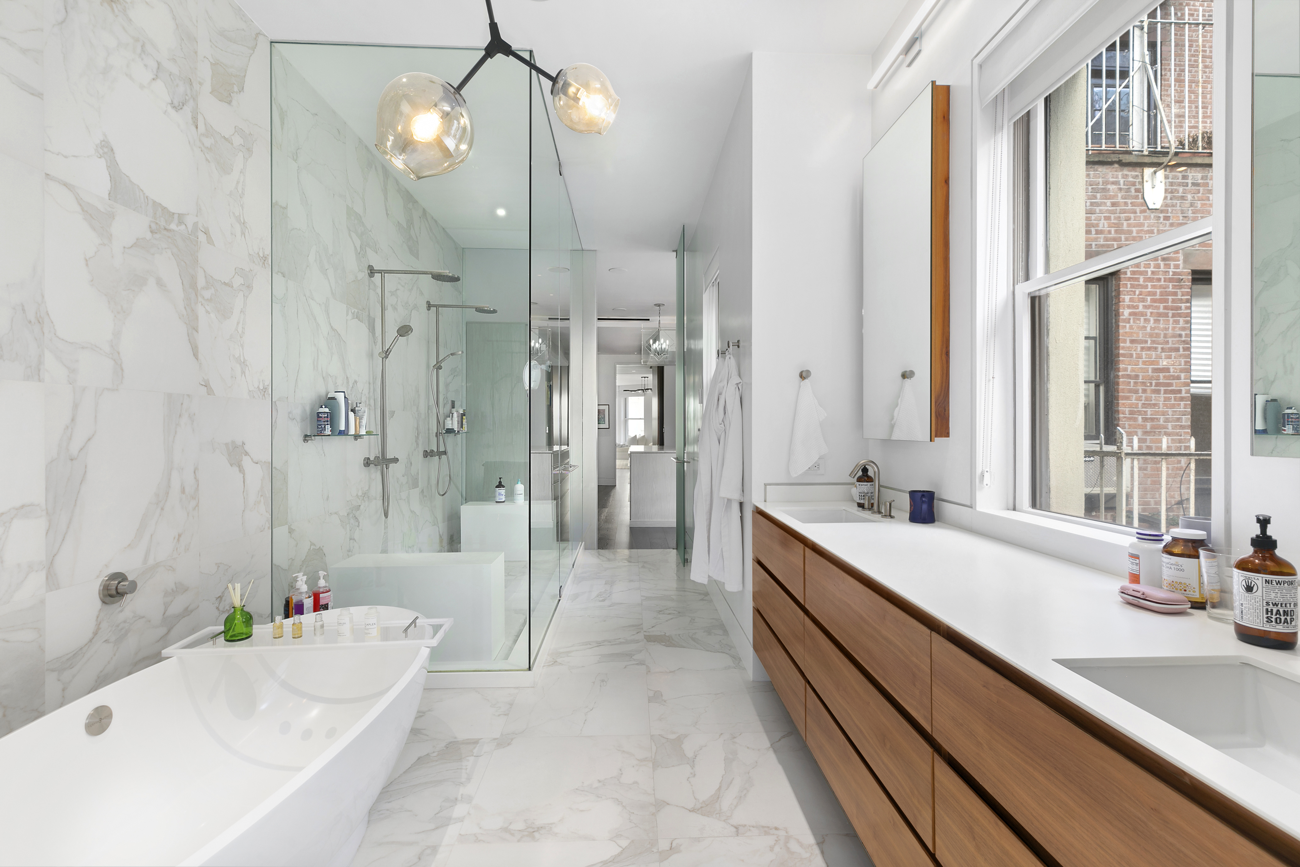 36 East 64th Street Manhattan, NY 10065 - Photo 15 of 27 a bathroom with a tub sink and shower