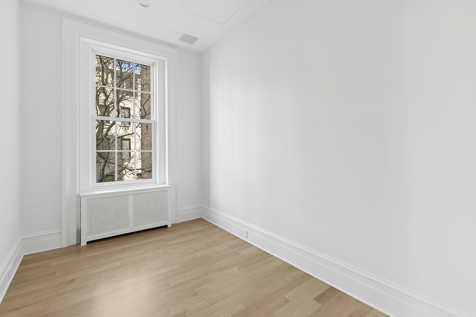 221 East 17th Street, Unit 2 Manhattan, NY 10003 - Photo 7 of 9 a view of an empty room with a window