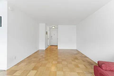 a kitchen with a checkered floor and white cabinets