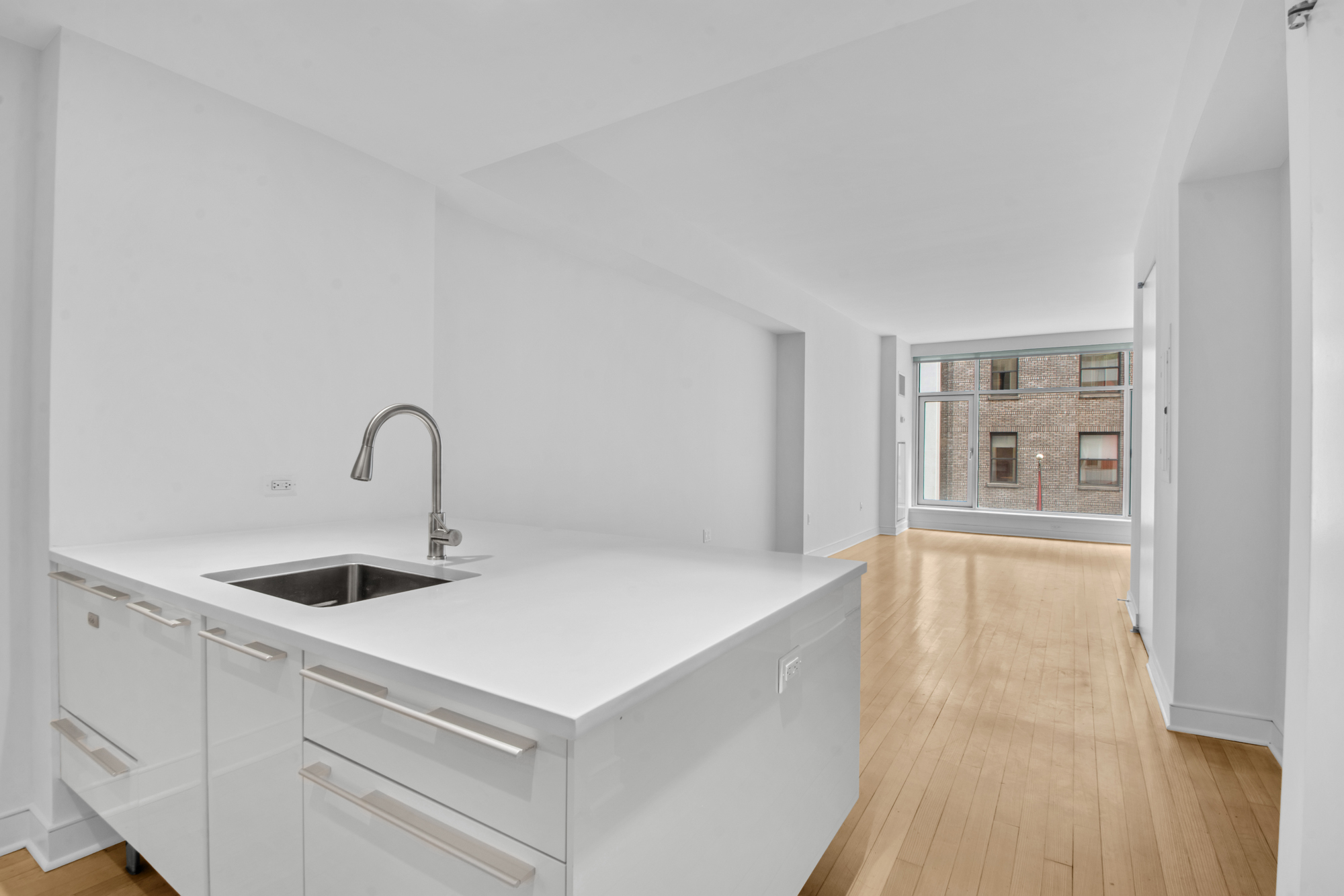 5 East 44th Street, Unit 5A Manhattan, NY 10017 - Photo 2 of 15 a kitchen with a sink and chandelier