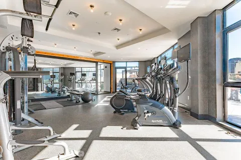 a room with gym equipment and a large window