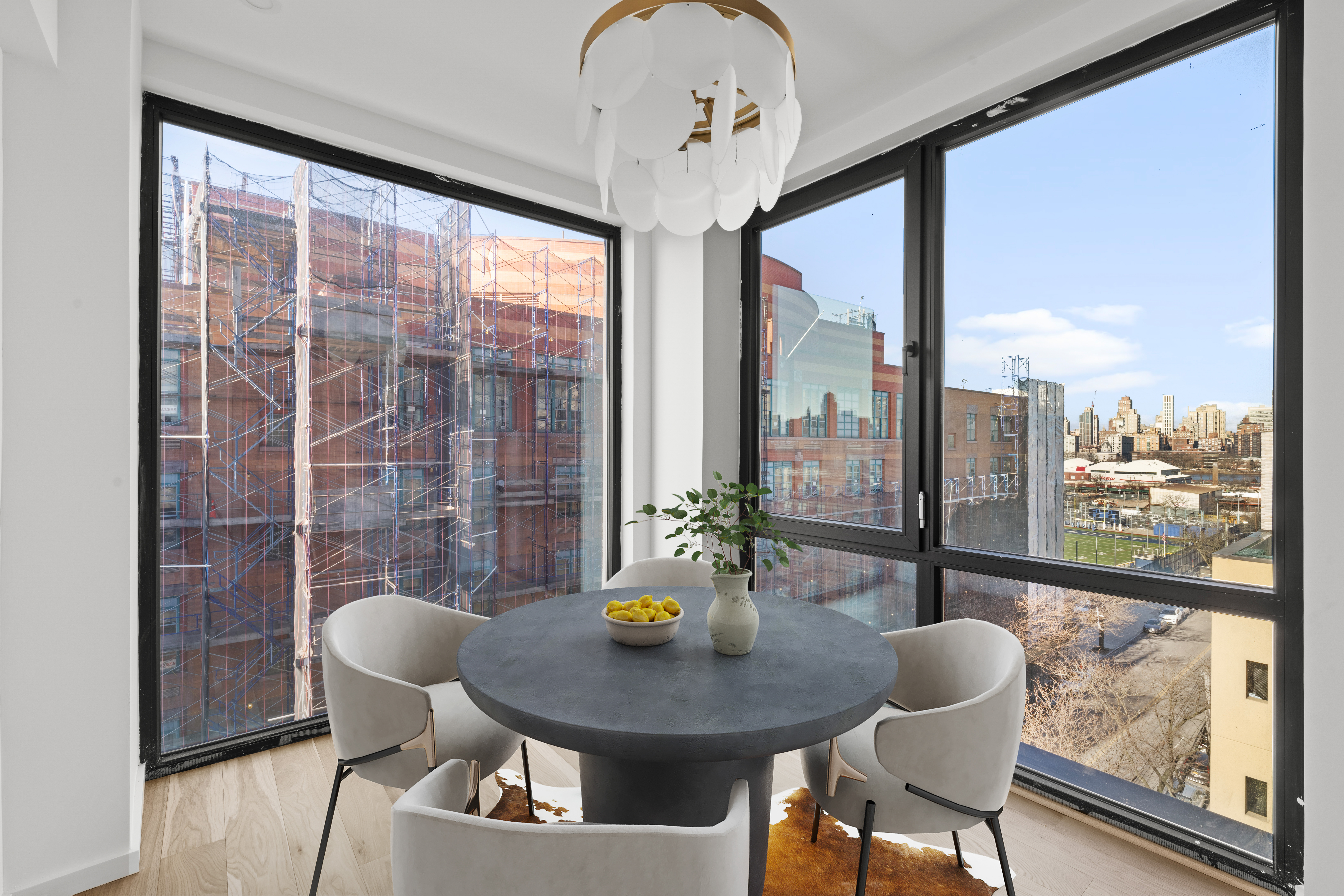 14-35 Broadway, Unit PH Queens, NY 11106 - Photo 7 of 24 a view of a dining room with furniture window and outside view