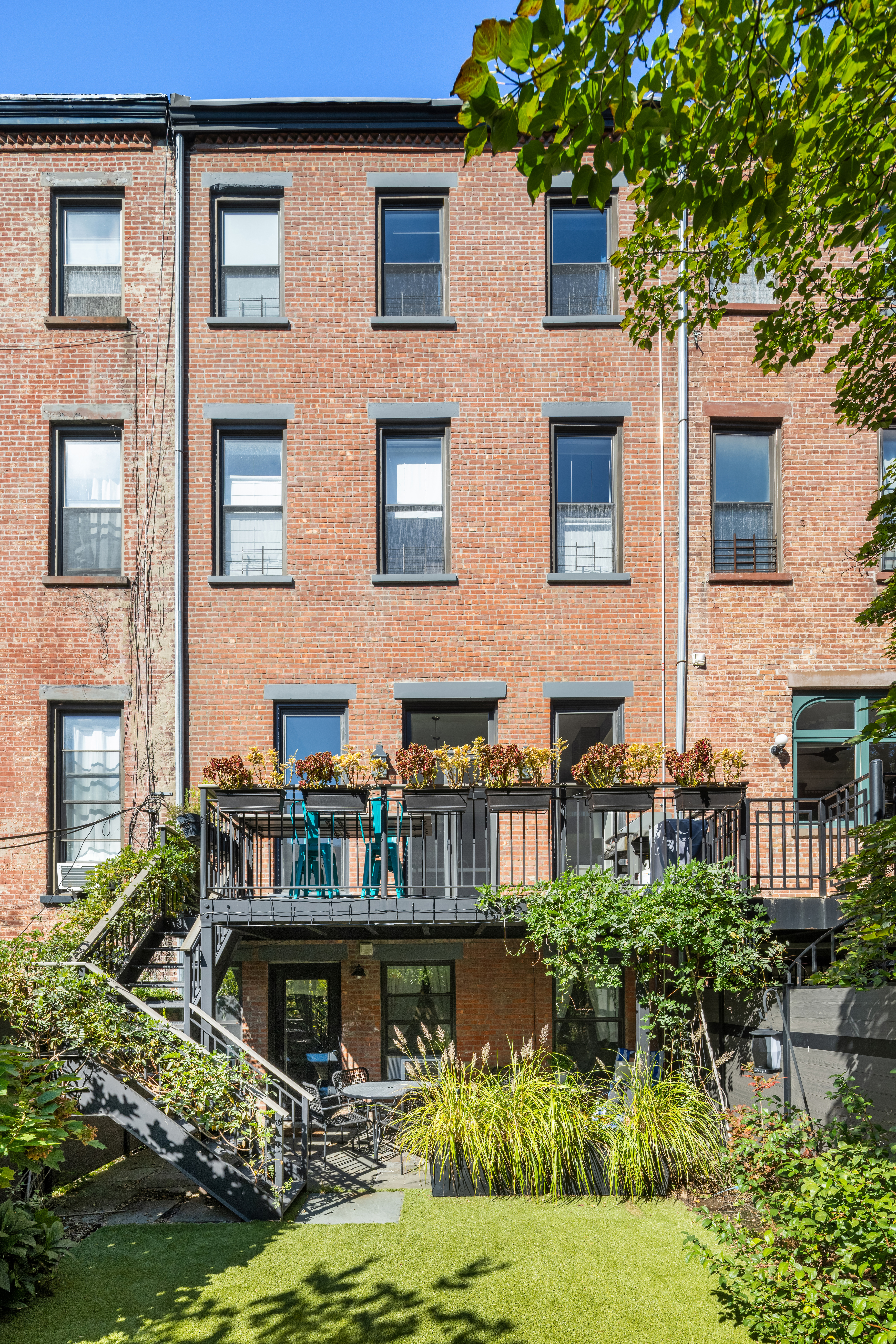 159 6th Avenue, Unit TRIPLEX Brooklyn, NY 11217 - Photo 17 of 19 a front view of house and yard with swimming pool and green space