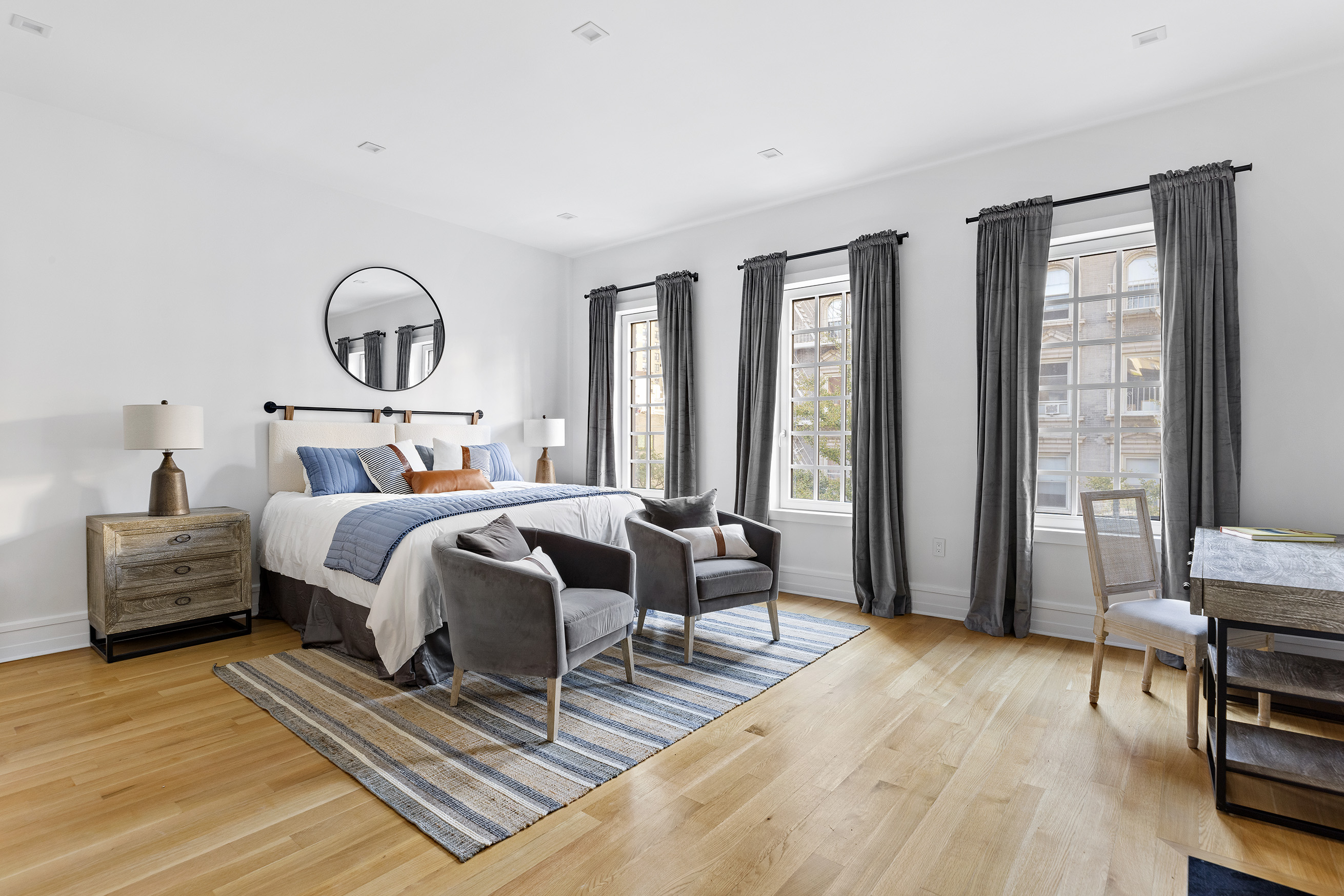 25 East 94th Street Manhattan, NY 10128 - Photo 17 of 33 a bedroom with a bed and wooden floor
