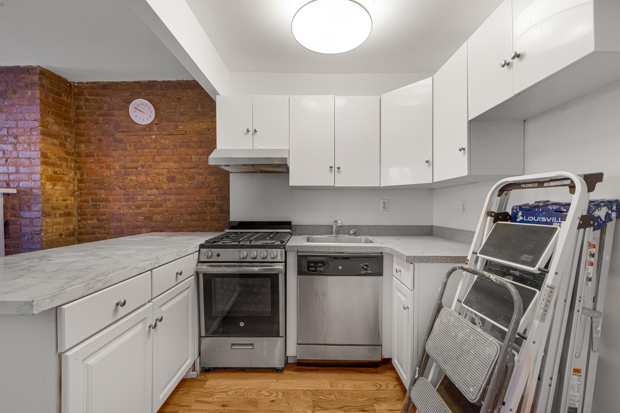 504 East 6th Street, Unit 6 Manhattan, NY 10009 - Photo 14 of 19 a kitchen with a stove and a sink