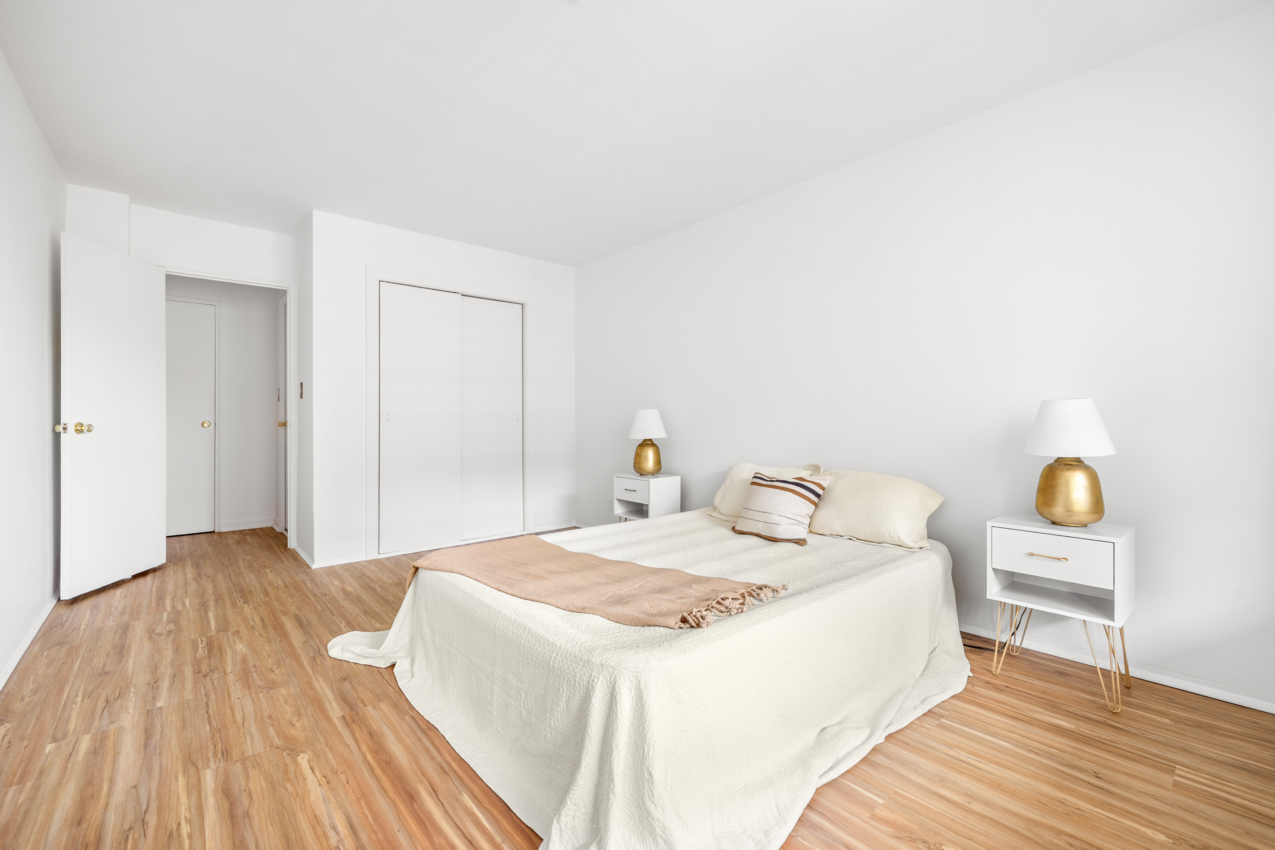 35-31 85th Street, Unit 6C Queens, NY 11372 - Photo 9 of 11 a bedroom with a bed and wooden floor