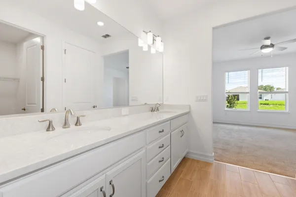 a bathroom with a sink double vanity and a mirror