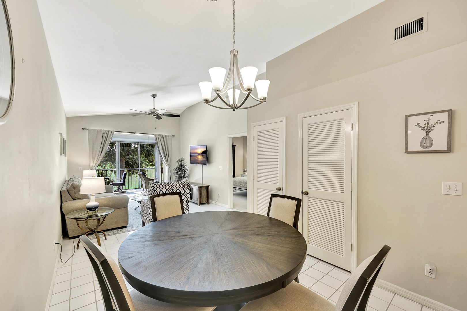 8228 Twelve Oaks Circle, Unit 323 Naples, FL 34113 - Photo 9 of 26 a view of a dining room with furniture wooden floor and chandelier