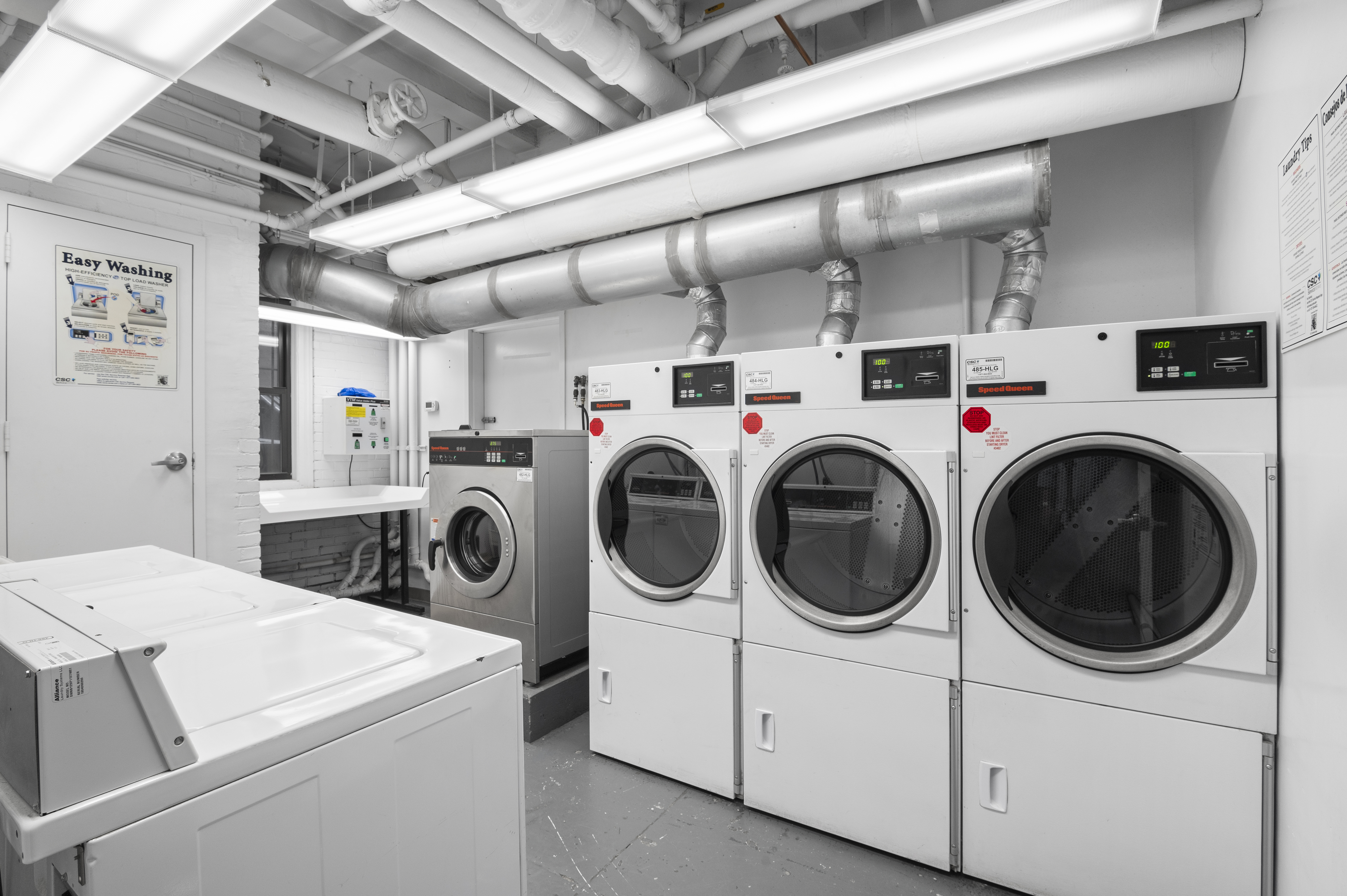 975 Park Avenue, Unit 1CD Manhattan, NY 10028 - Photo 7 of 14 a utility room with dryer and washer