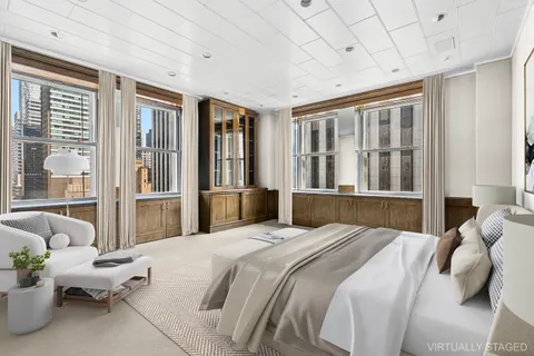 a bedroom with a bed and glass windows