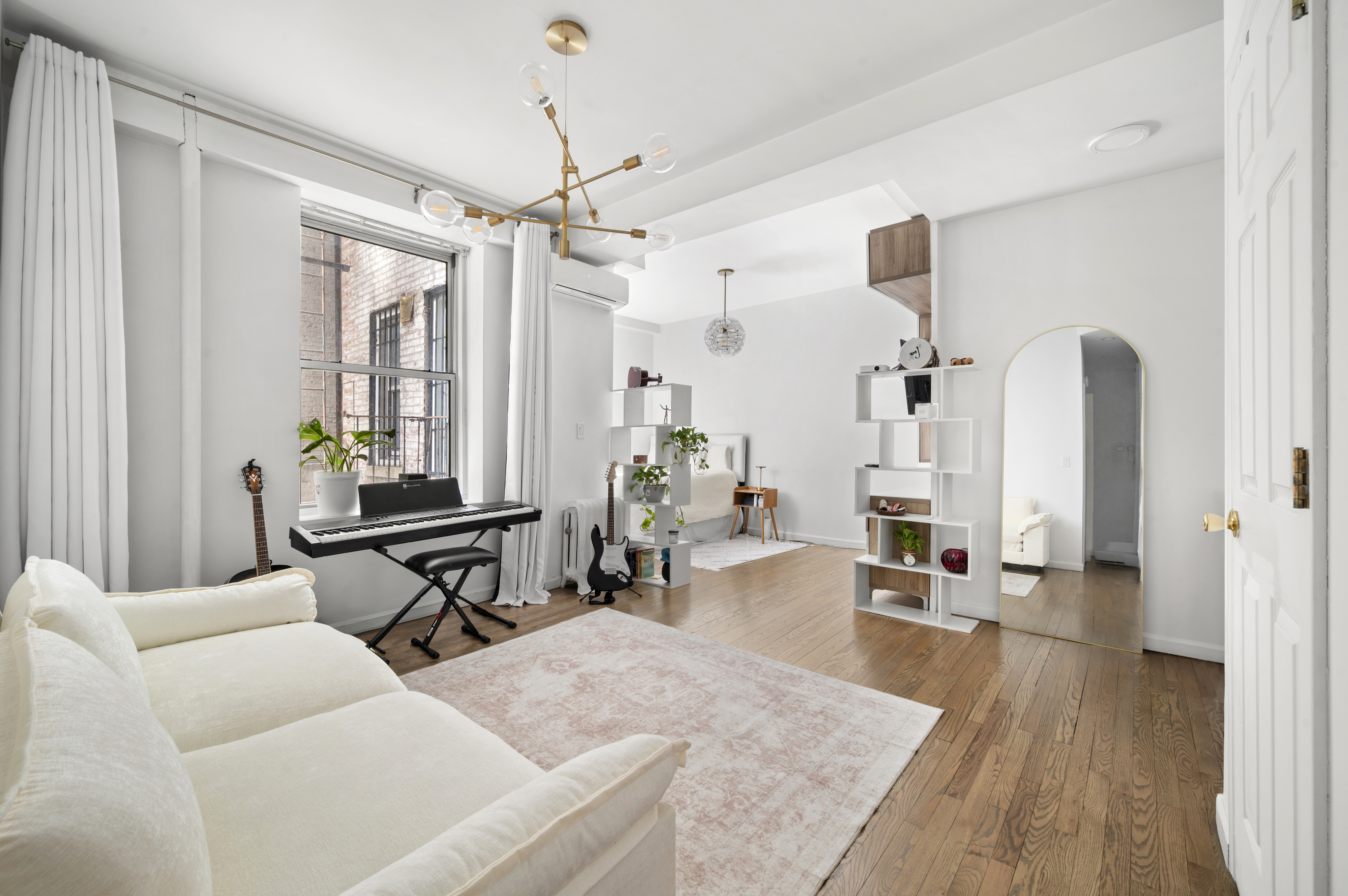 251 West 98th Street, Unit DD Manhattan, NY 10025 - Photo 1 of 6 a living room with furniture a chandelier and a wooden floor