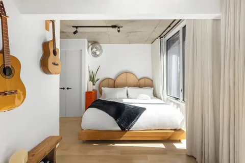 a bedroom with a bed and a dresser