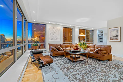 a living room with furniture rug and large window