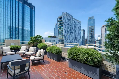 a view of a patio with couches and potted plants