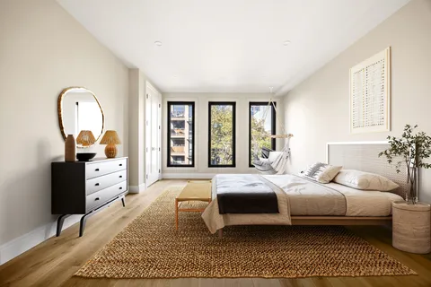 a bedroom with a large bed and a dresser