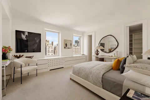 a bedroom with bed and a flat screen tv