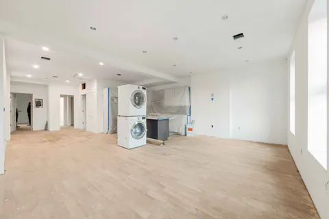 a view of a kitchen with a refrigerator and a sink