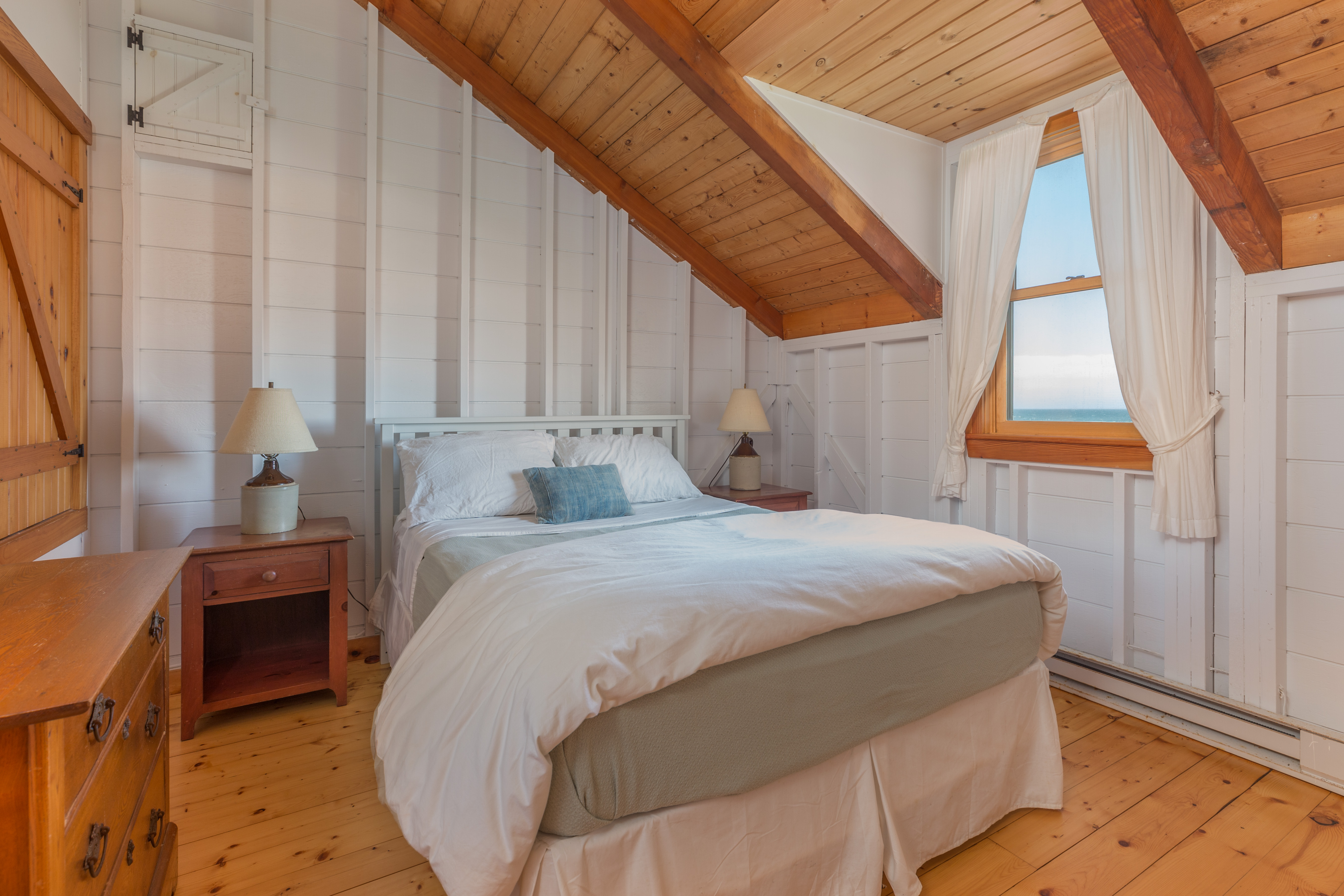 65 Nobadeer Avenue Nantucket, MA 02554 - Photo 12 of 20 a bed sitting in a bedroom next to a window