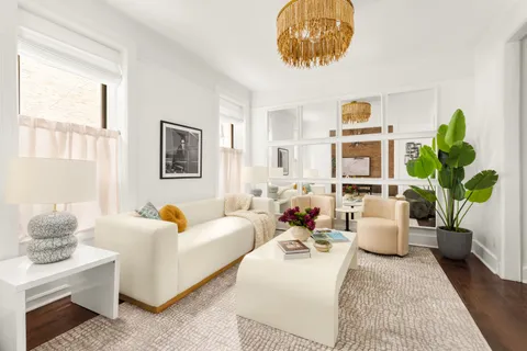 a living room with furniture and a potted plant