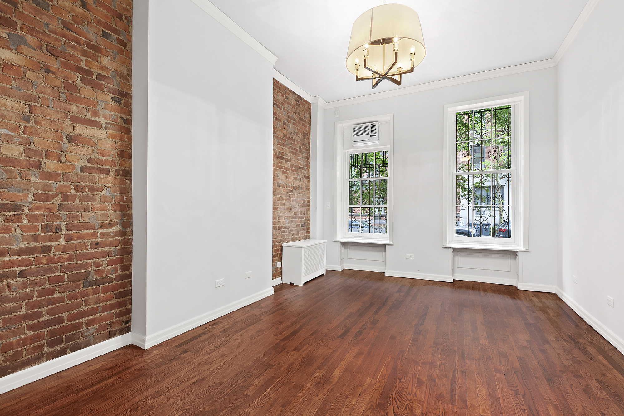 522 East 82nd Street, Unit 1 Manhattan, NY 10028 - Photo 13 of 16 a view of a livingroom with wooden floor and a window