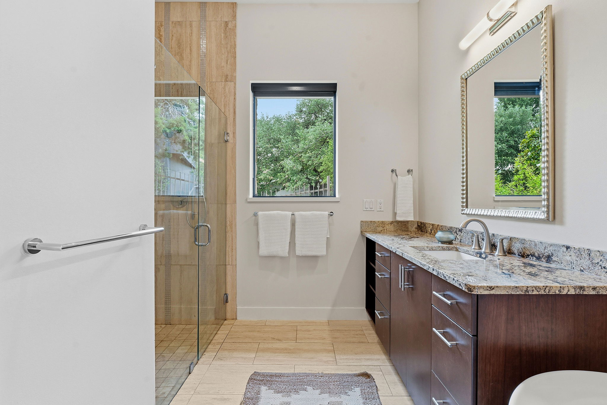 3605 Robbins Road Austin, TX 78730 - Photo 24 of 51 a spacious bathroom with a granite countertop sink a toilet and shower