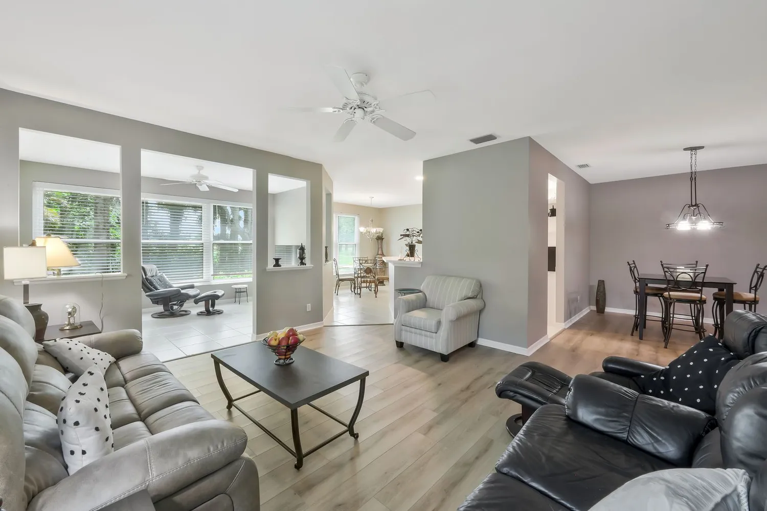 a living room with furniture and floor to ceiling windows