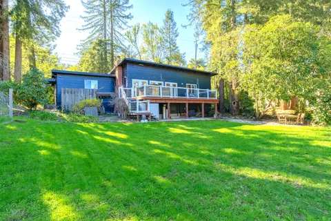 a view of a house with a yard and sitting area