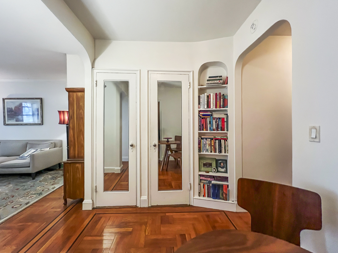 208 East 28th Street, Unit 4A Manhattan, NY 10016 - Photo 6 of 12 a living room with furniture and a book shelf
