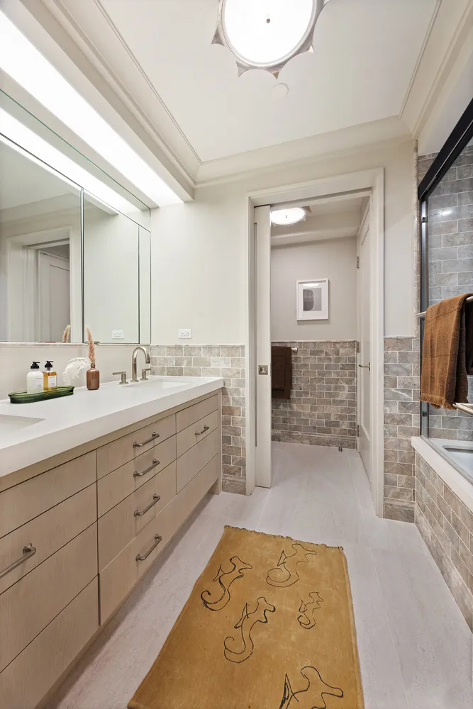 a spacious bathroom with a double vanity sink and a mirror