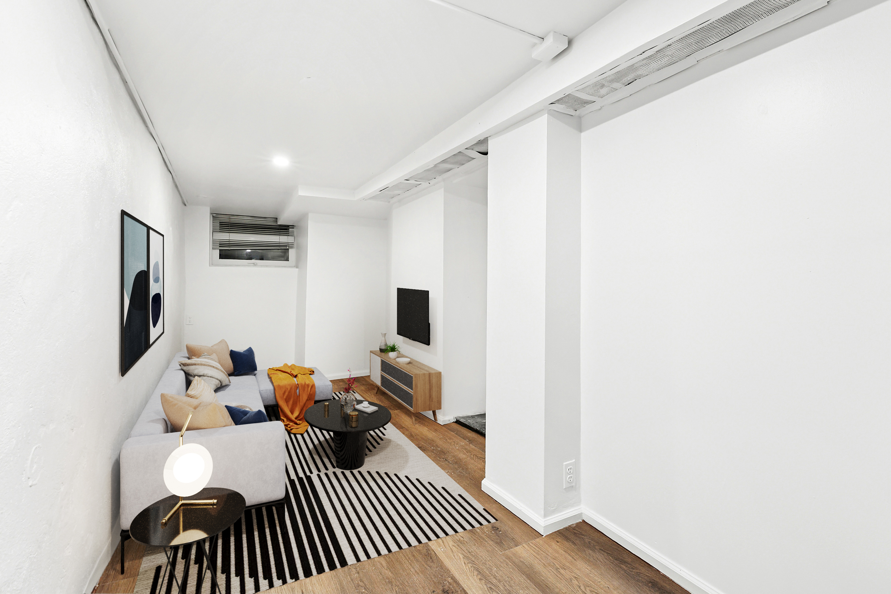 205 West 20th Street, Unit 1A Manhattan, NY 10011 - Photo 4 of 7 a bedroom with a bed and a flat screen tv