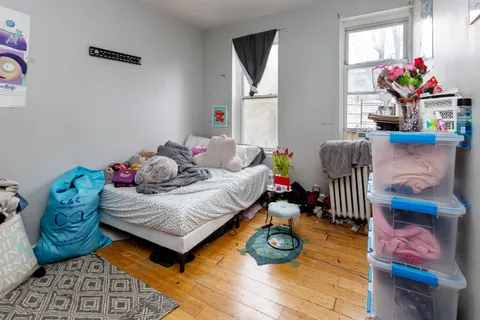 a bedroom with furniture and a wooden floor