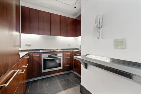 a kitchen with granite countertop wood cabinets and stainless steel appliances