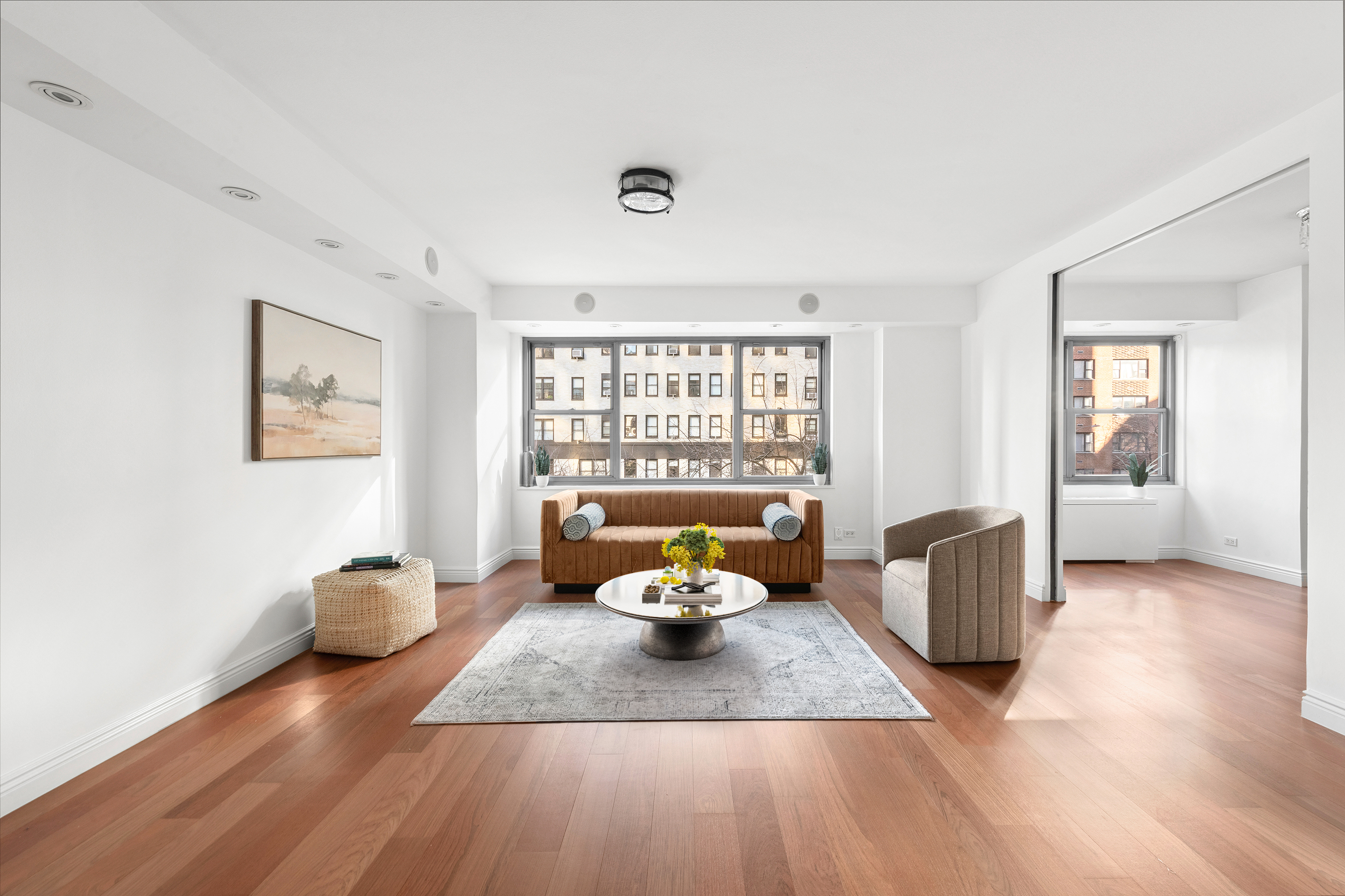 400 East 56th Street, Unit 3D Manhattan, NY 10022 - Photo 3 of 24 a living room with furniture and a large window