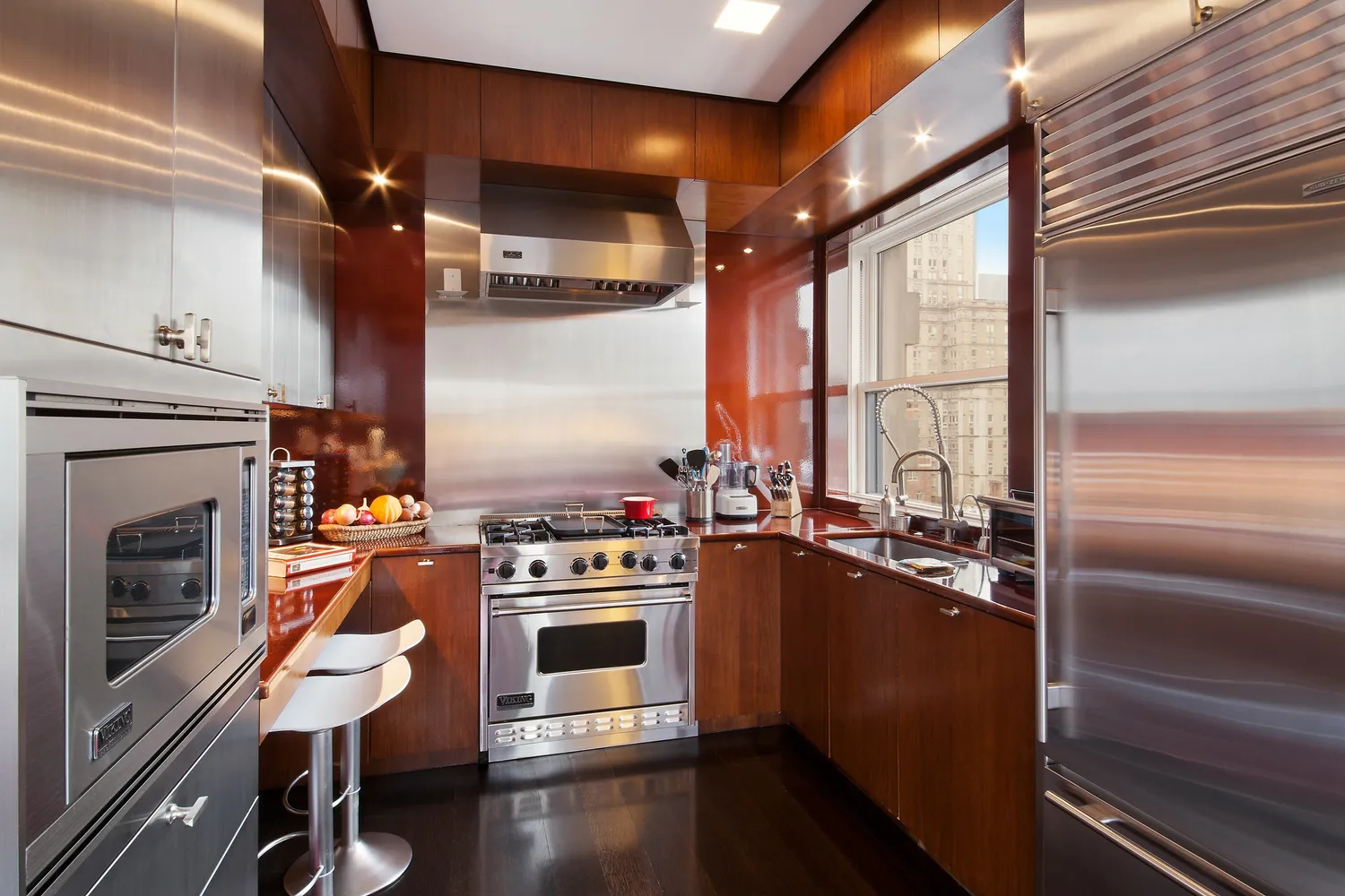 a kitchen with stainless steel appliances a stove a sink and a refrigerator
