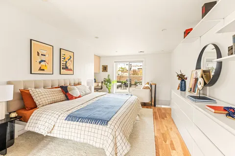 a bedroom with a bed and a large window